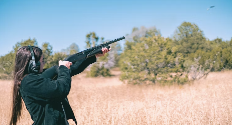 Woman shooting shotgun